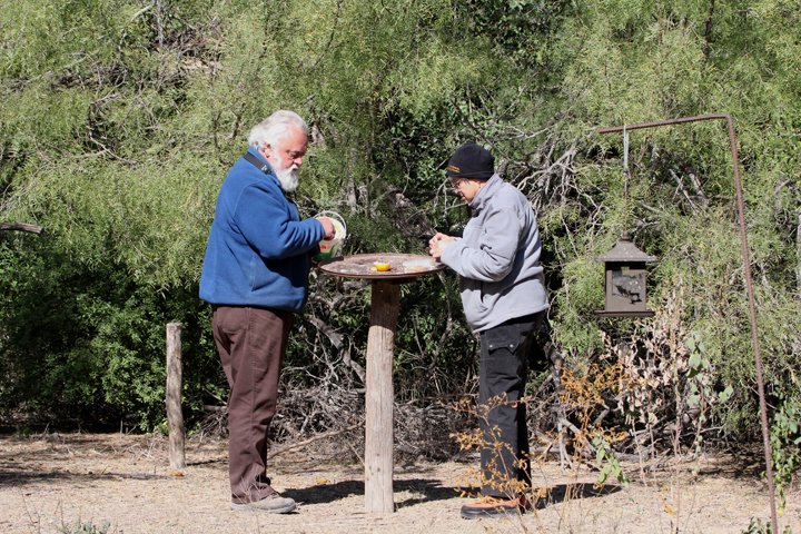 Merle and Lois, two of the long-time volunteers, fill a feeding station.