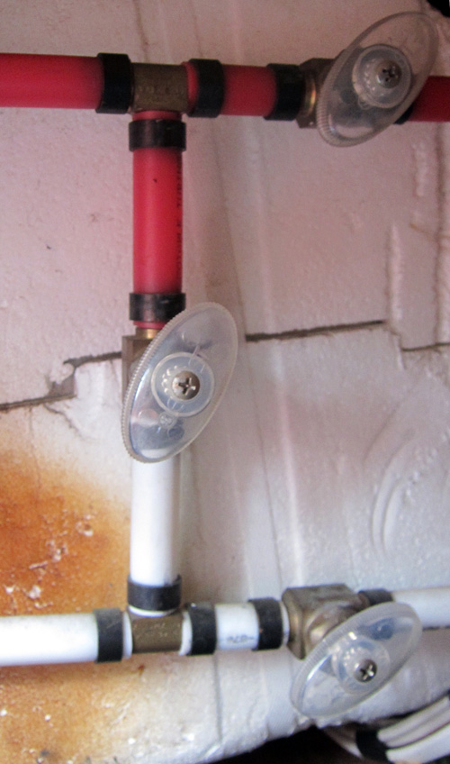 The valves on the horizontal pipes are closed in winter and the one on the vertical is opened, bypassing hot water tank.