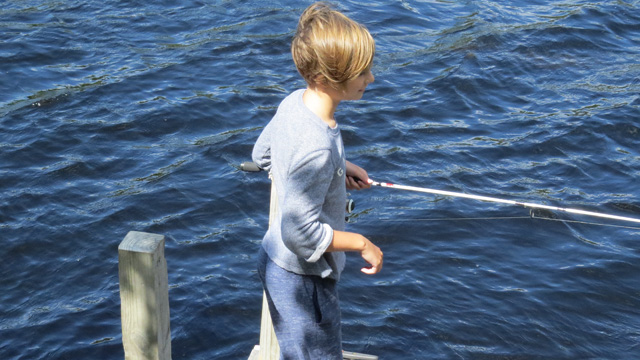 This young angler had a small bass on the other end of her pole.