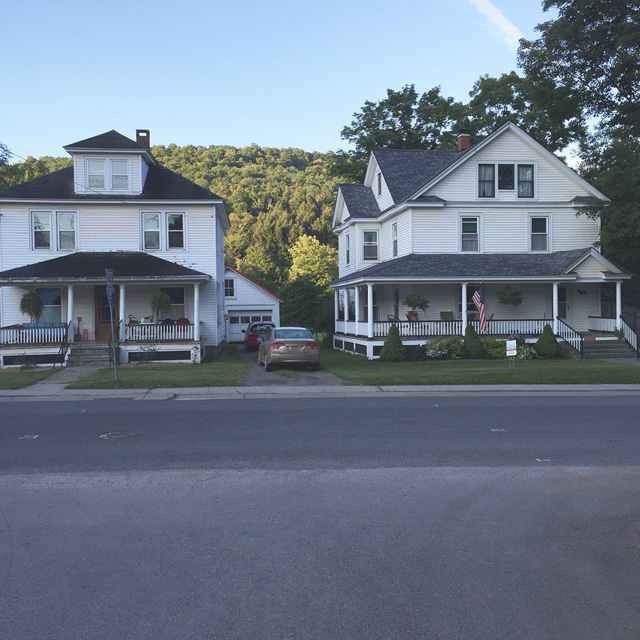 The front porch of the house on the right is an informal community gathering spot.