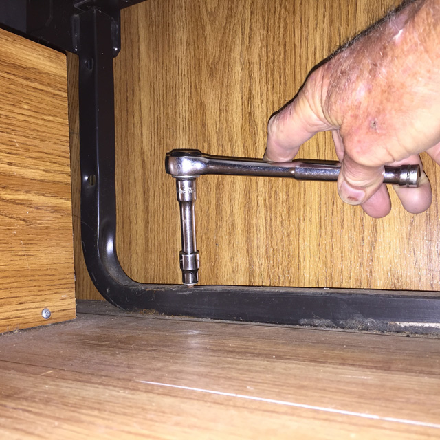 It helps to have long arms when crawling under the couch to remove screws.